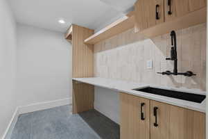 Laundry room with a sink and recessed lighting