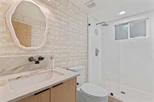 Bathroom featuring vanity, a shower stall, and recessed lighting