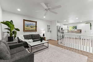 Living area featuring light wood finished floors, recessed lighting, and ceiling fan