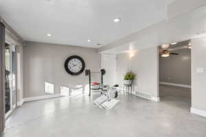Exercise area with concrete flooring and recessed lighting