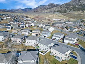 Aerial overview of property's location with a mountainous background and nearby suburban area
