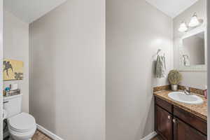 Half bath with vanity and light wood finished floors
