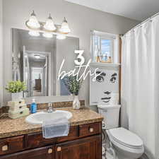 Full bath featuring vanity and curtained shower