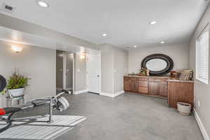 Workout area featuring finished concrete floors and recessed lighting