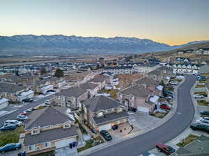 Aerial overview of property's location featuring nearby suburban area and mountains