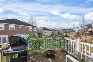 Wooden deck with a residential view and a mountain view