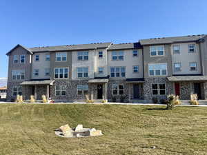 Rear view of house with a lawn