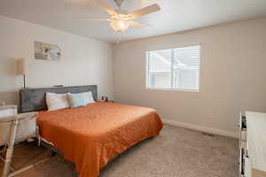 Bedroom featuring carpet and a ceiling fan