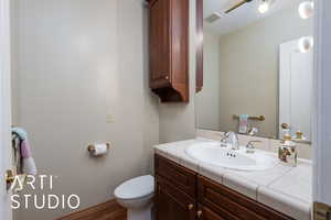Half bath with vanity and wood finished floors