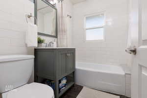 Full bath featuring shower / bath combination with curtain and vanity
