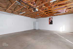 Garage featuring freestanding refrigerator and a garage door opener