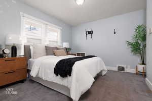 Carpeted bedroom with baseboards