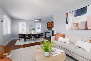 Living area with wood finished floors and ceiling fan