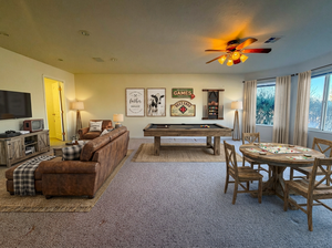 Game room with pool table, carpet flooring, and a ceiling fan