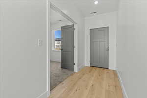 Corridor featuring baseboards and light wood-type flooring