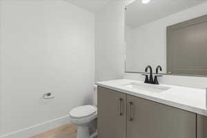 Half bath featuring vanity and light wood-style flooring