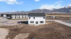 View of side of home featuring a mountain view and a patio