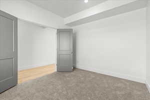 Carpeted spare room featuring baseboards