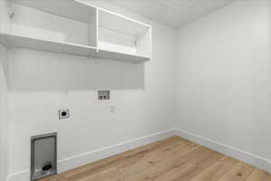 Laundry area featuring hookup for a washing machine, hookup for an electric dryer, and light wood-type flooring