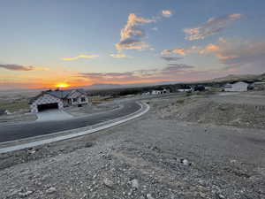View of asphalt street featuring a mountain view