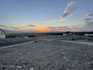 View of asphalt street featuring a mountain view