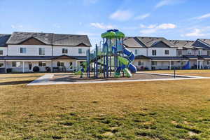 Community playground with a lawn and a residential view