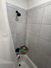 Full bathroom featuring shower / bath combination with curtain