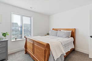 Bedroom featuring light colored carpet