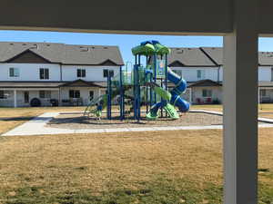 Community jungle gym featuring a yard and a residential view