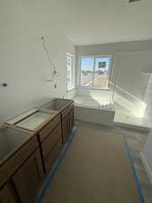 Full bath with a bath and a textured ceiling