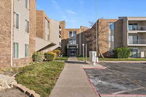 View of community featuring uncovered parking