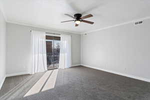 Carpeted spare room with ornamental molding and ceiling fan