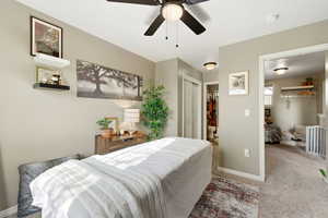 Bedroom featuring a closet, carpet, and a ceiling fan