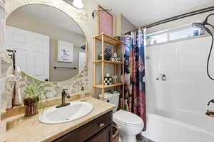 Bathroom with vanity and shower / tub combo with curtain