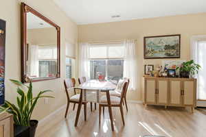 Dining space with plenty of natural light and light wood-type flooring