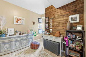 Office area featuring wooden walls and light wood-type flooring