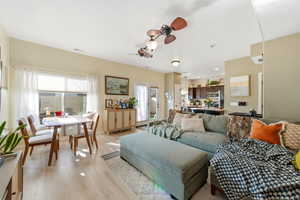 Living room featuring ceiling fan, light wood-style floors, and recessed lighting