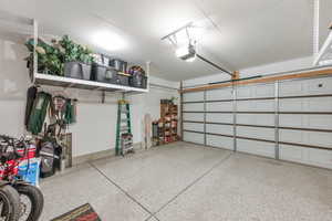 Garage with baseboards and a garage door opener
