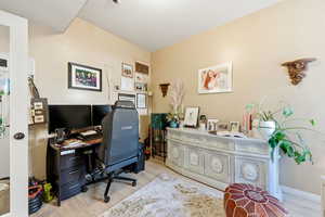 Office space with light wood-style flooring
