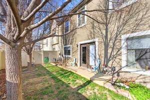 Back of property featuring stucco siding, a deck, and a fenced backyard
