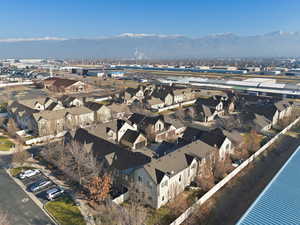 Aerial overview of property's location featuring nearby suburban area and a mountain backdrop