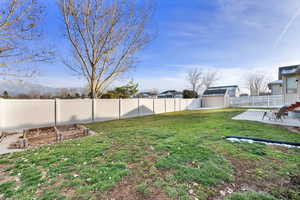 Fenced backyard with a patio and a garden