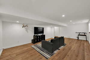Living area featuring light wood-type flooring and recessed lighting
