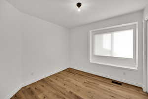 Empty room with light wood finished floors and baseboards