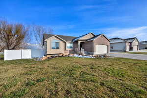 Ranch-style home featuring brick siding, concrete driveway, and an attached garage
