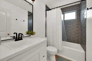 Bathroom featuring shower / bath combo and vanity