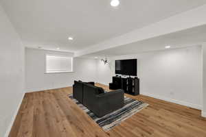 Living room featuring light wood-style flooring and recessed lighting