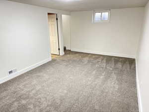Basement featuring carpet and baseboards