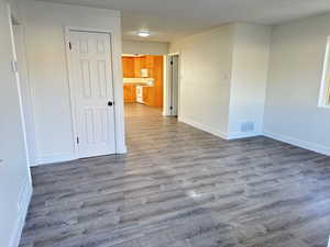 Unfurnished room featuring dark wood-style floors