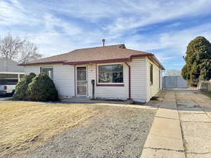 View of front of house featuring a shingled roof
